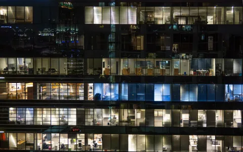 Office building at night with illuminated floors
